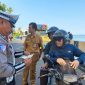 Salah satu petugas Sat Lantas Polres Parepare, memeriksa kelengkapan surat-surat kendaraan bagi pengendara yang sedang melintas saat sedang operasi Patuh pallawa 2025